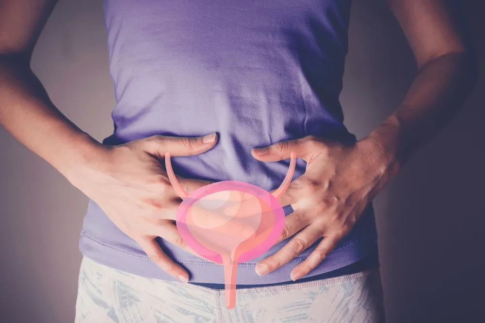 Person with pelvic pain holding bladder area, illustrating interstitial cystitis and allergic inflammation