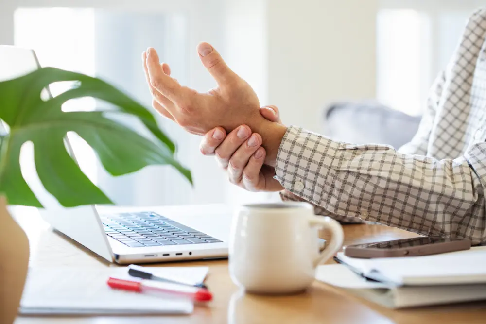 Corporate worker experiencing wrist pain mid meeting