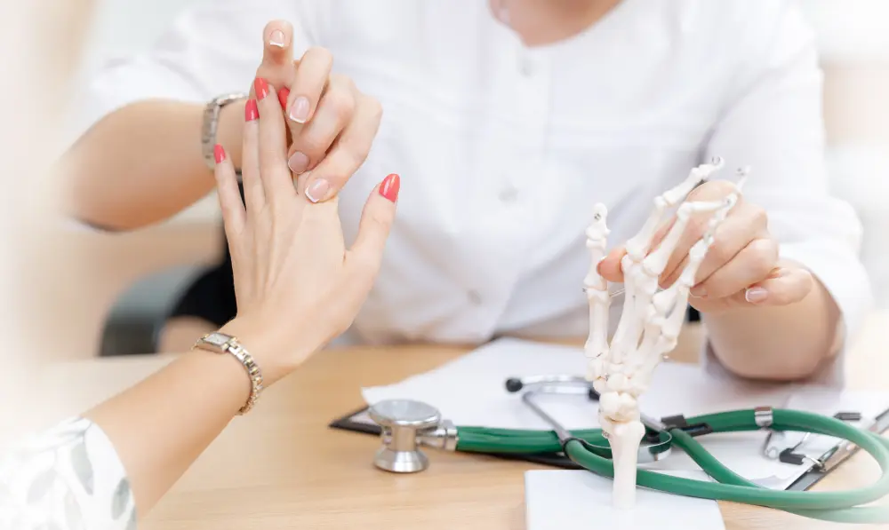 Doctor explaining to women using a bone model