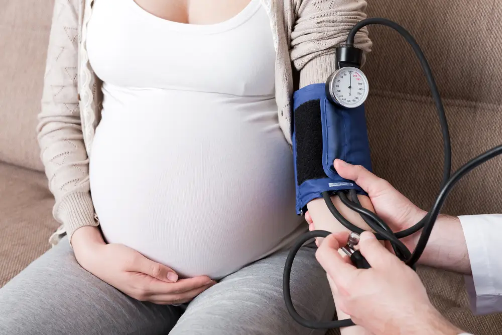 Doctor measuring pregnant woman’s blood pressure