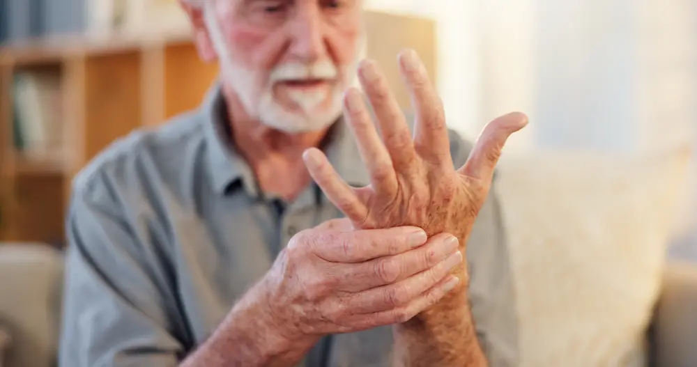 Elderly man experiencing wrist pain