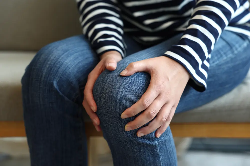 Woman suffering from knee pain