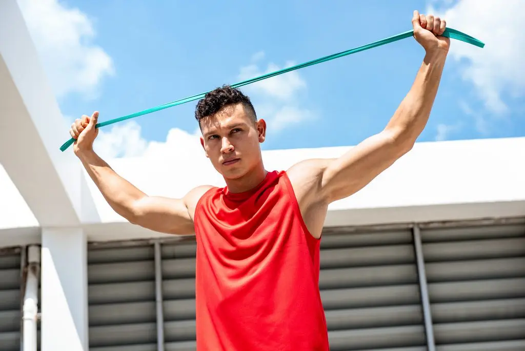 Athletic man stretching with a resistance band