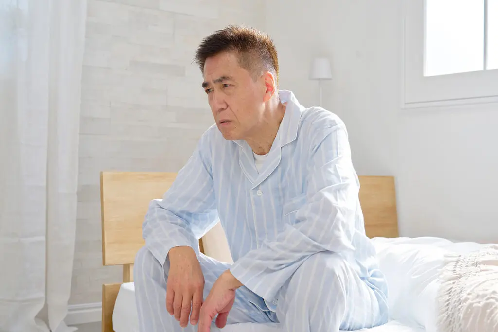 An elderly man experiencing fatigue from rheumatoid arthritis