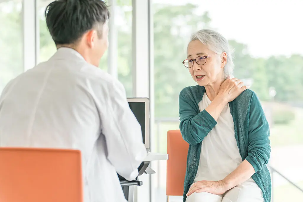 An elderly woman suffering from rheumatoid arthritis